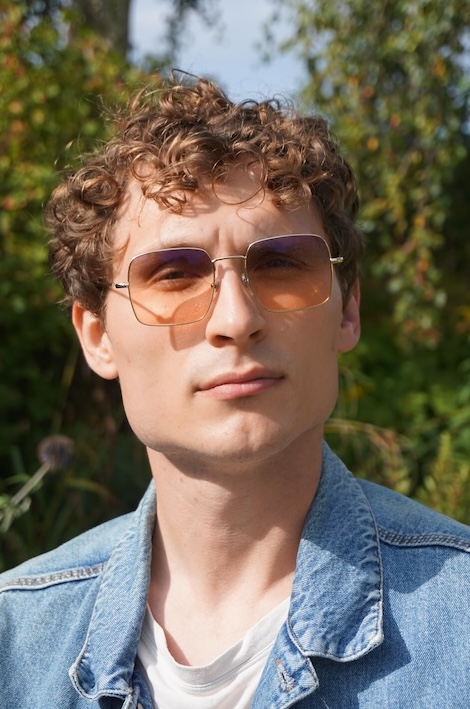 wonderful headshot of young man with glasses